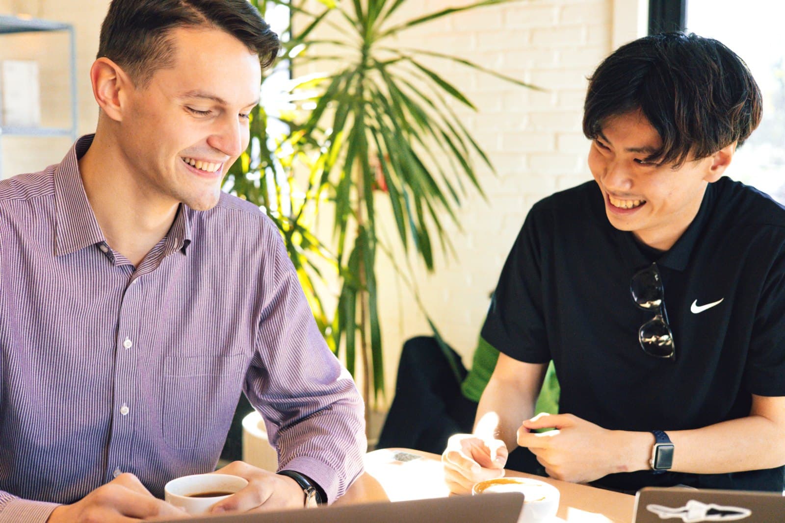 A consultation over coffee at a table with a laptop